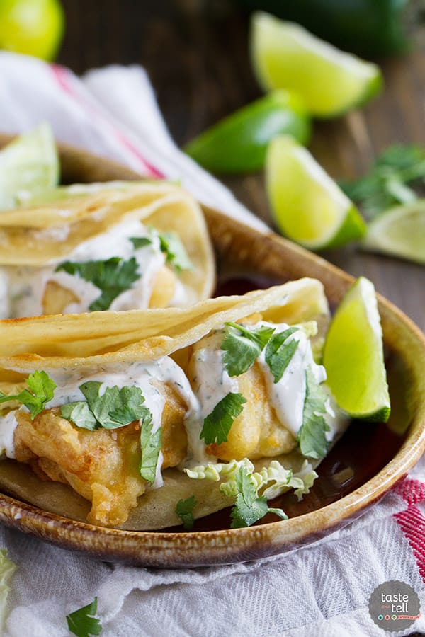 A taste of San Diego, these fried fish tacos have pieces of battered, fried fish inside corn tortillas, topped with a creamy, tangy white sauce.