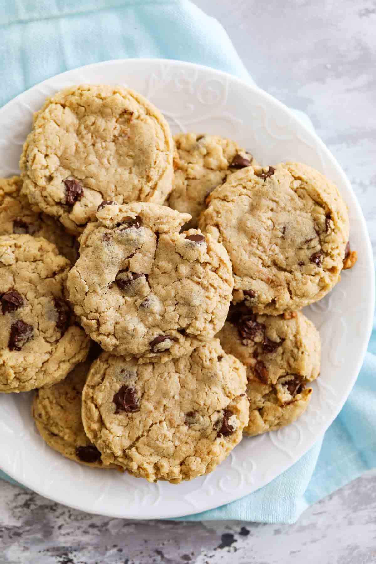 cookies made with peanut butter, oatmeal, and chocolate chips on a plate with a blue towel