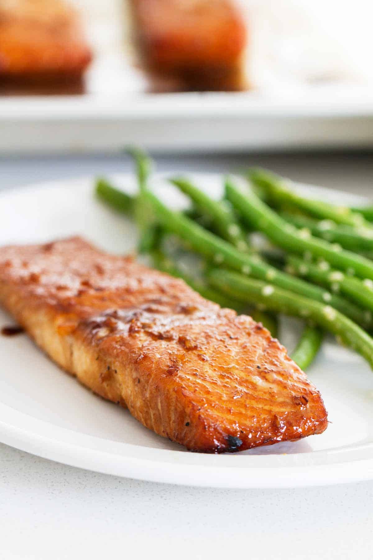 Soy Ginger Salmon on a plate served with green beans.