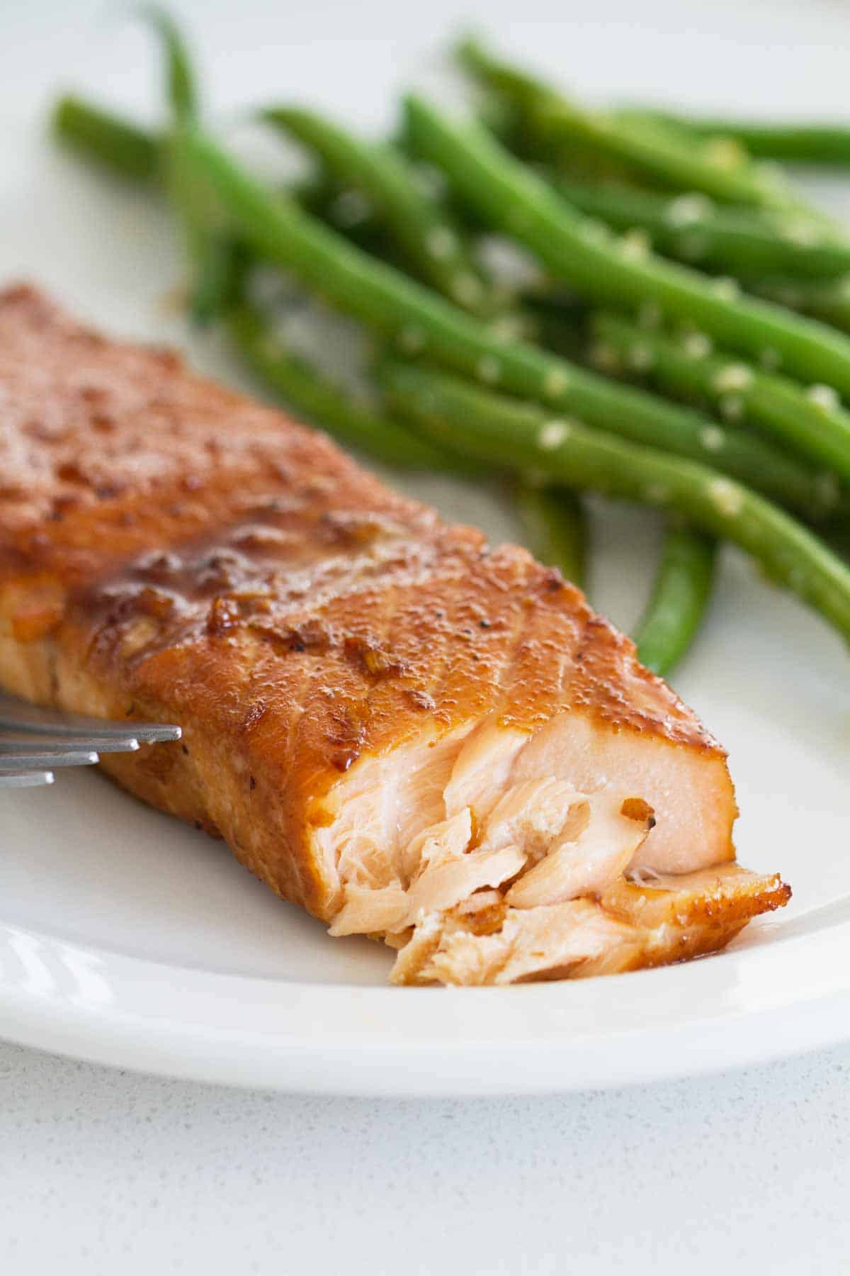 flaked Soy Ginger Salmon dinner with green beans on the plate.