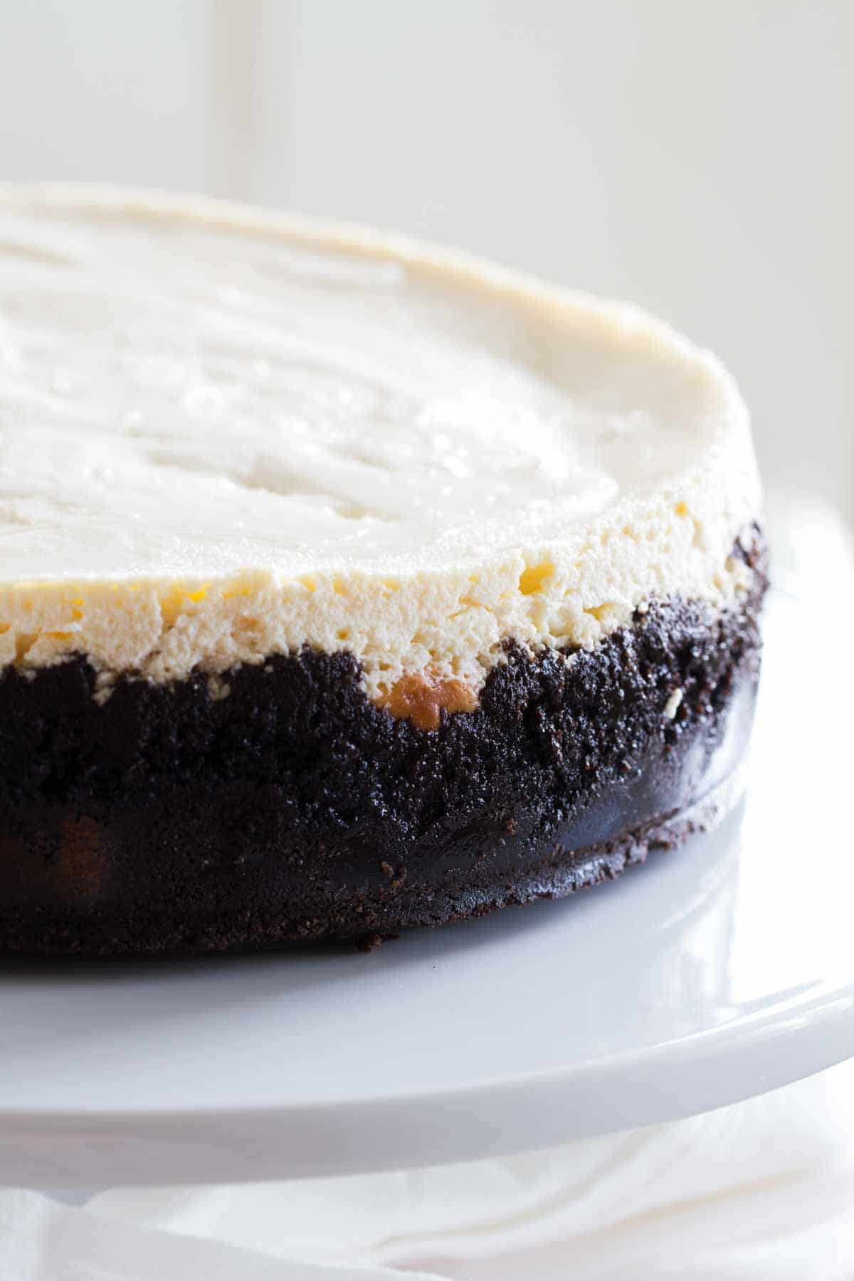 side of sour cream cheesecake showing the Oreo crust.
