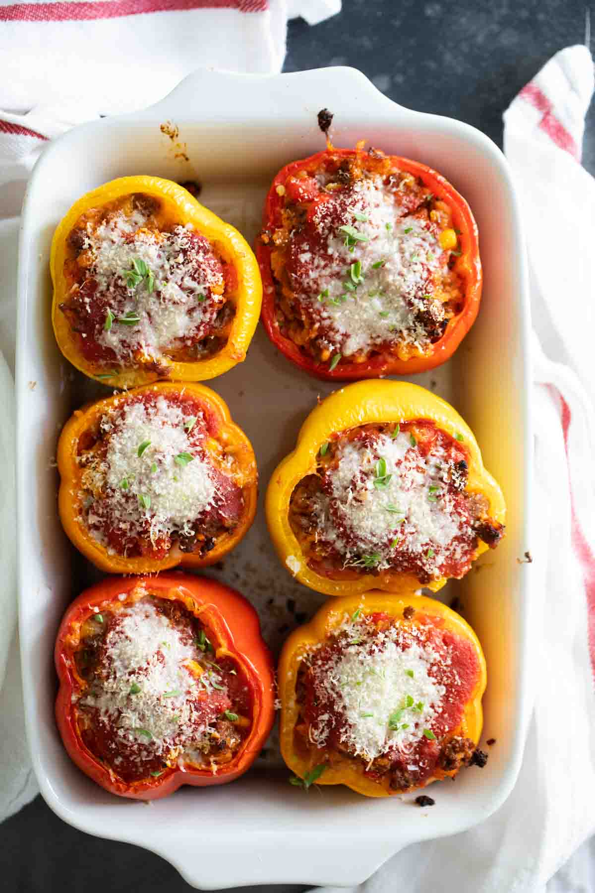 Stuffed Peppers with Ground Beef topped with cheese and herbs