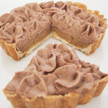 Milk Chocolate and Caramel Tart with slice cut