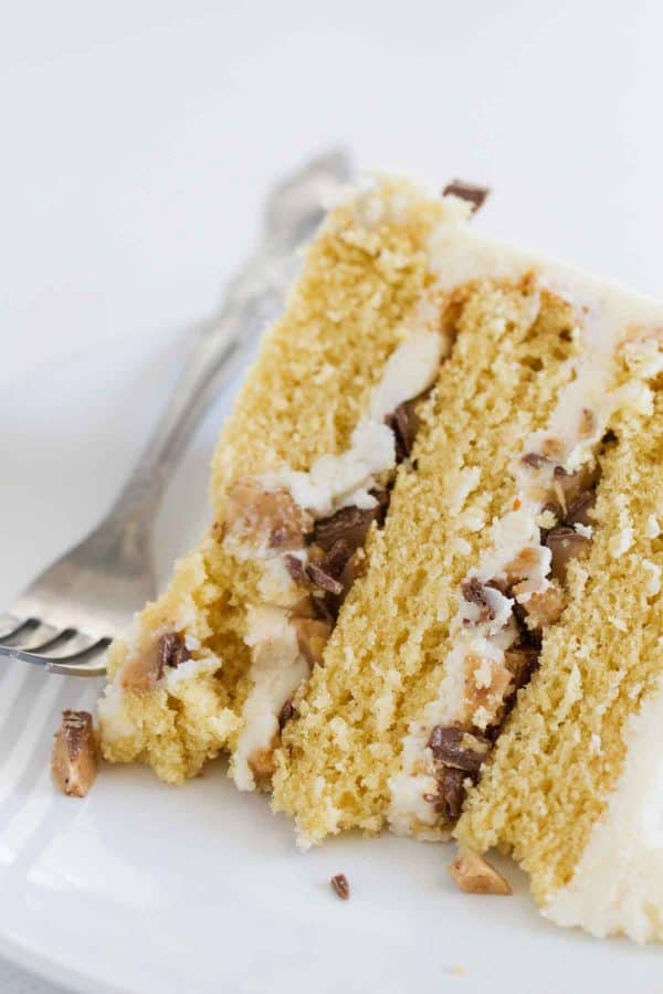 Sugar is cooked to deepen the flavor of this moist Burnt Sugar Candy Bar Cake. Browned butter and crushed candy bars finish off this sweet and delicious cake.