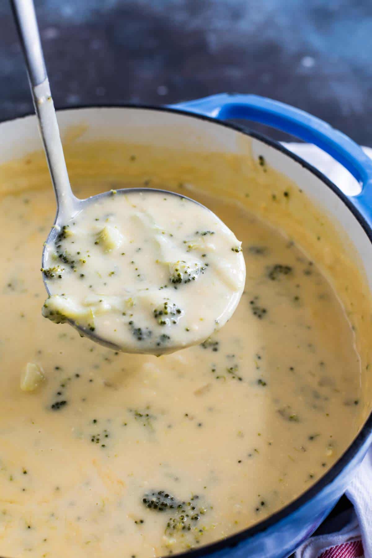 ladle full of soup showing texture of broccoli