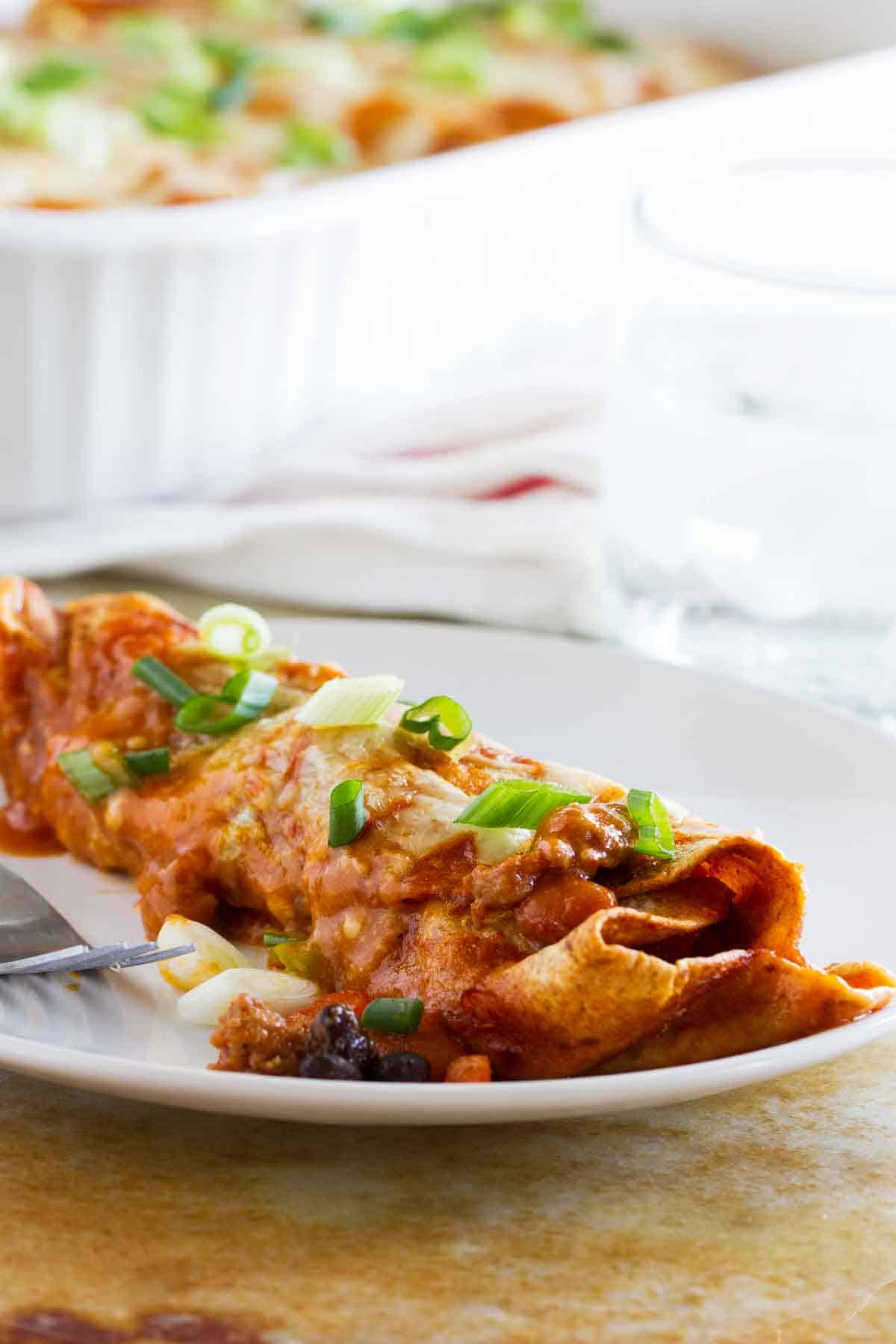 Sausage and Bean enchilada on a plate.