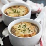 two bowls of French onion soup topped with bread and cheese