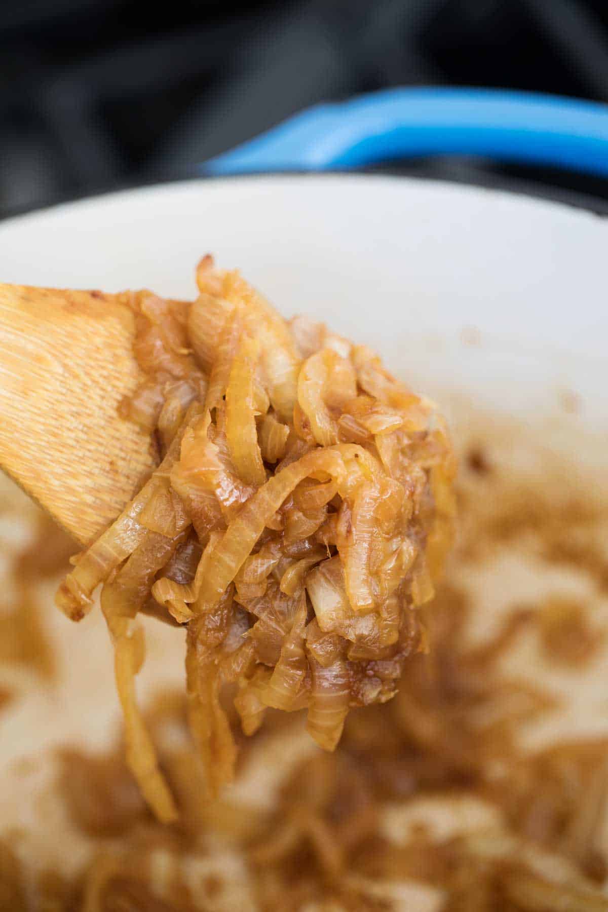 wooden spoon full of caramelized onions