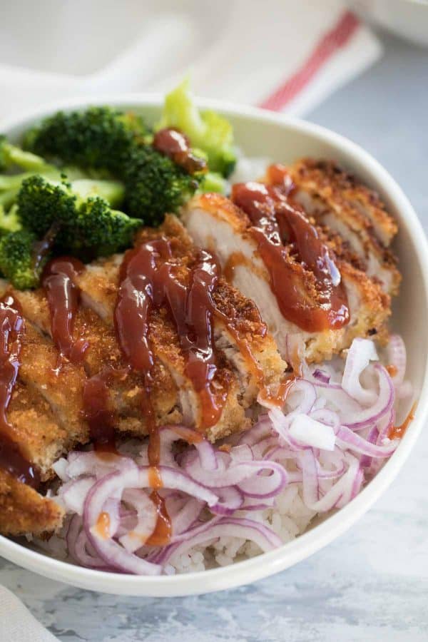 Pork chops are coated with panko breadcrumbs, pan fried, then served over rice with an easy sweet and sour sauce. Quick pickled onions and steamed broccoli finish off the bowls. Sweet and Sour Pork in Rice Bowls