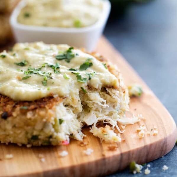 Green chile crab cake with a bite taken from it.