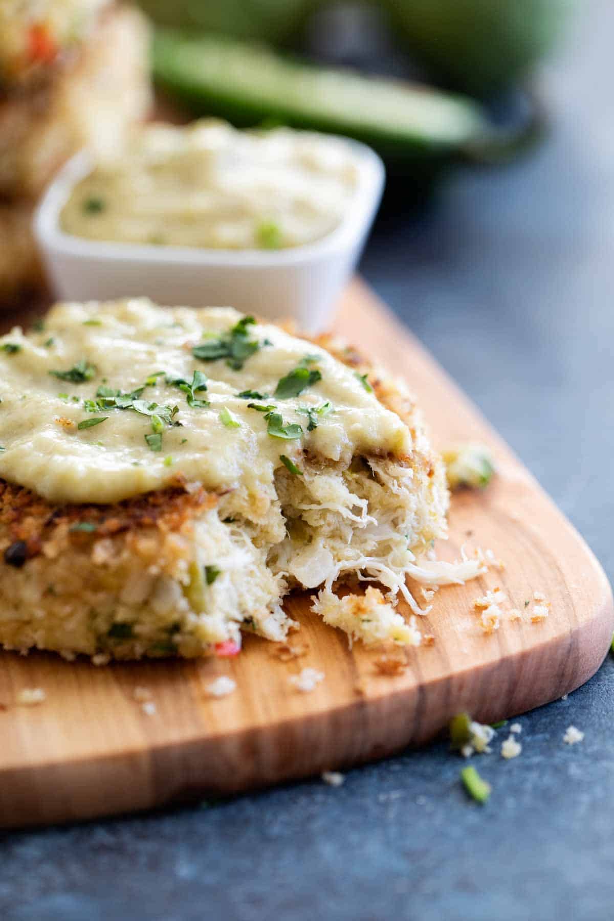 Green chile crab cake with a bite taken from it.