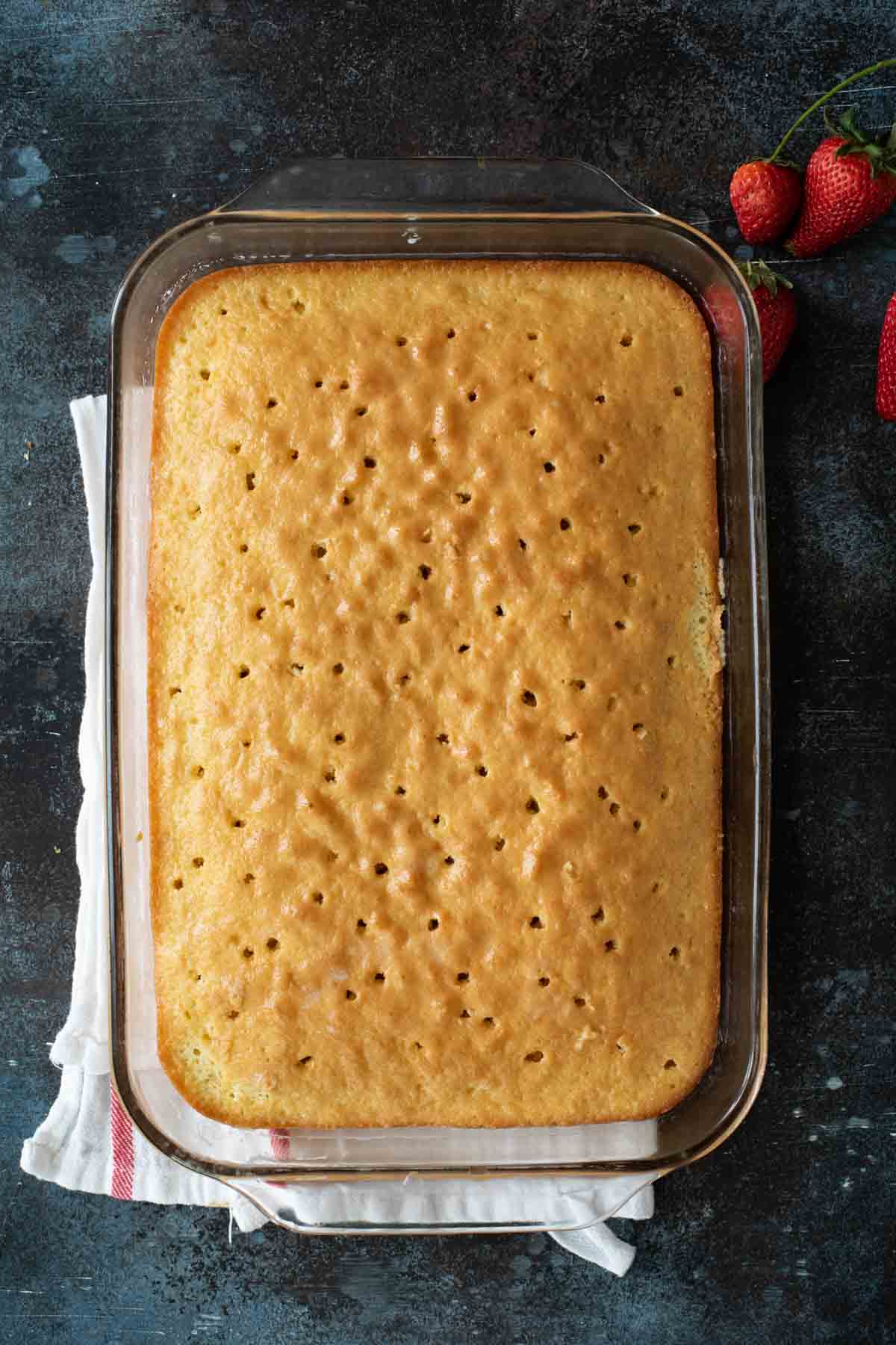 poking holes in a cake for tres leches cake