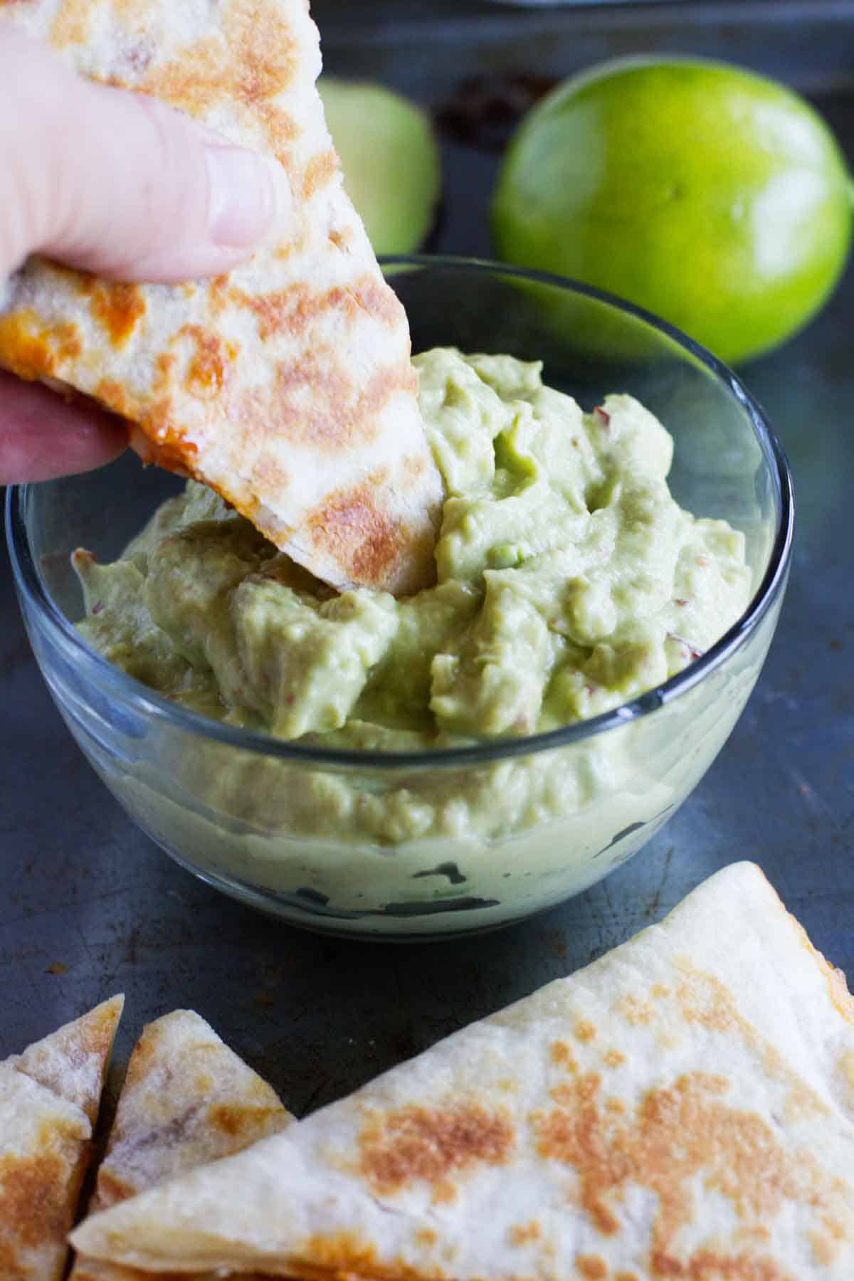 Dipping a shrimp quesadilla into smoky guacamole.