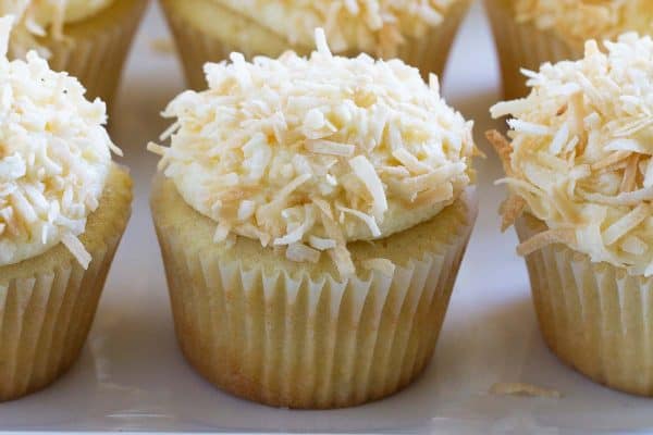 True coconut lovers will appreciate these Coconut Snowball Cupcakes! Coconut cupcakes are filled with a coconut pastry cream and then frosted with a coconut buttercream. Top them off with toasted coconut for the ultimate coconut treat!