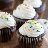 Devil's Food Cupcakes with Fluffy Frosting topped with sprinkles.