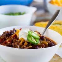 The perfect all-around chili recipe, this Warm You Up Beef and Bean Chili has all of your favorite chili ingredients, plus some bacon for added smokiness.