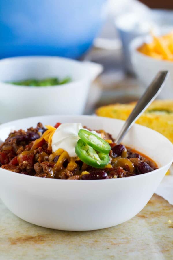 The perfect all-around chili recipe, this Warm You Up Beef and Bean Chili has all of your favorite chili ingredients, plus some bacon for added smokiness.