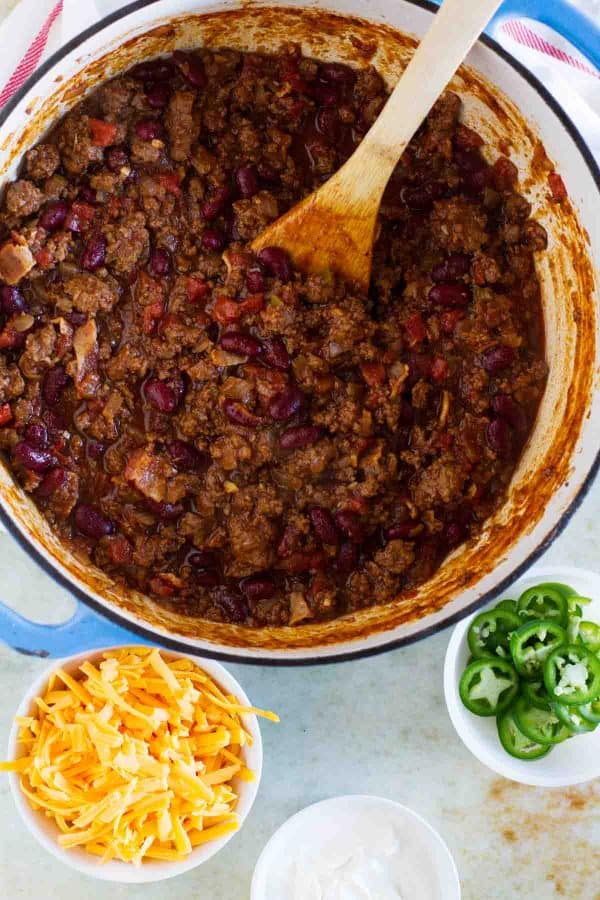 The perfect all-around chili recipe, this Warm You Up Beef and Bean Chili has all of your favorite chili ingredients, plus some bacon for added smokiness.