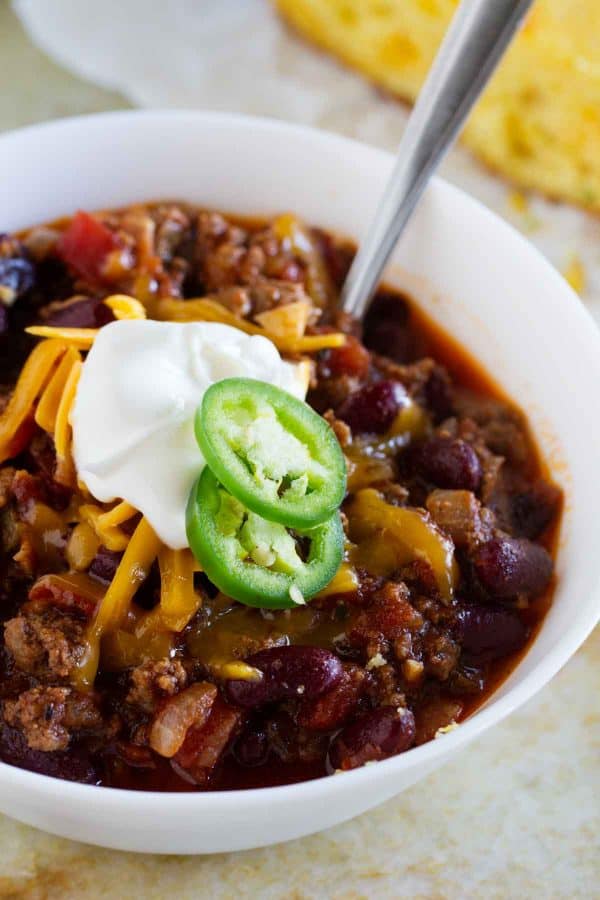 The perfect all-around chili recipe, this Warm You Up Beef and Bean Chili has all of your favorite chili ingredients, plus some bacon for added smokiness.