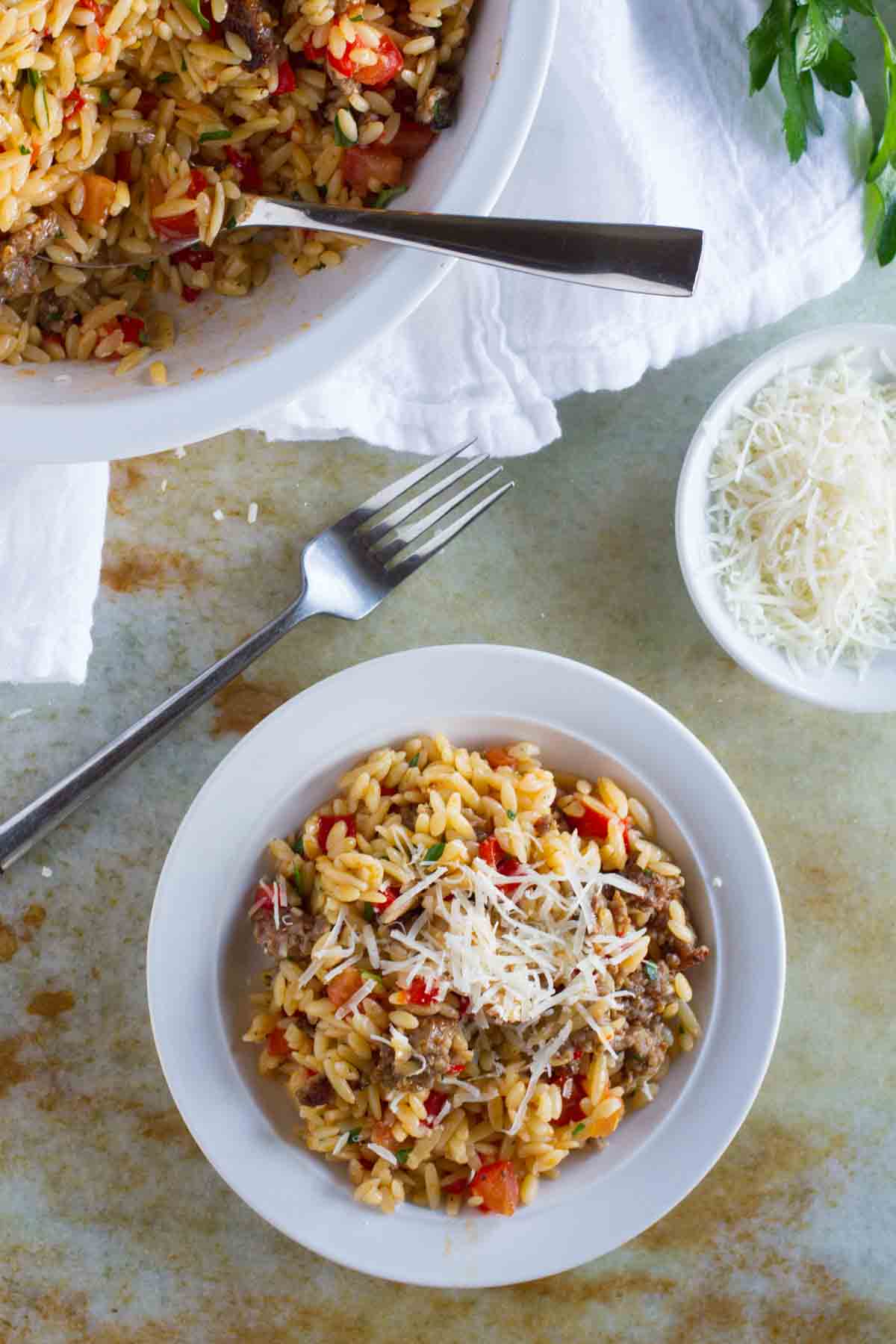 Orzo with Italian Sausage and Peppers topped with Parmesan cheese.