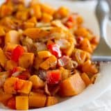 The perfect Sweet Potato Hash – sweet potatoes are combined with bacon, onions and sweet red peppers in this easy stovetop side dish.