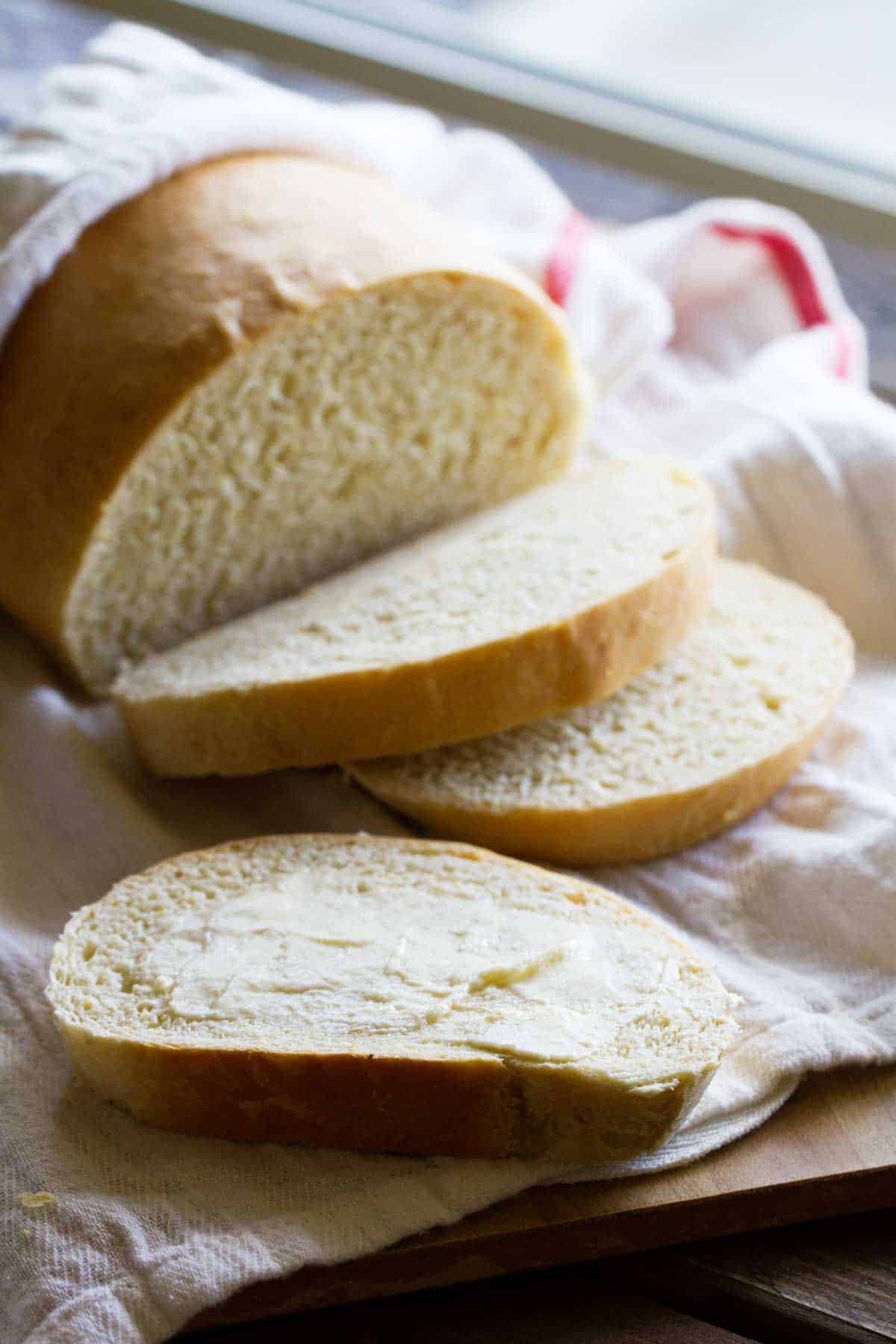 Slice of polenta bread with butter spread on top.