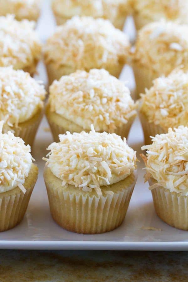 True coconut lovers will appreciate these Coconut Snowball Cupcakes! Coconut cupcakes are filled with a coconut pastry cream and then frosted with a coconut buttercream. Top them off with toasted coconut for the ultimate coconut treat!