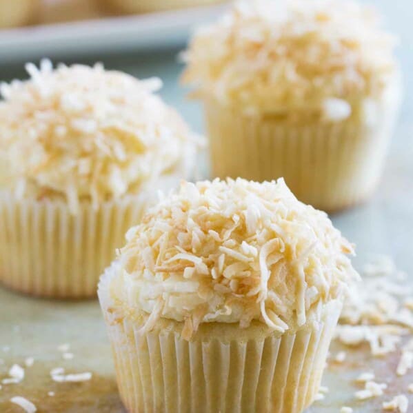 True coconut lovers will appreciate these Coconut Snowball Cupcakes! Coconut cupcakes are filled with a coconut pastry cream and then frosted with a coconut buttercream. Top them off with toasted coconut for the ultimate coconut treat!