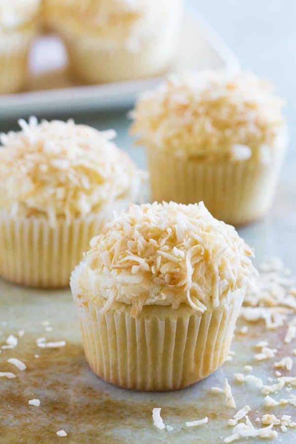 True coconut lovers will appreciate these Coconut Snowball Cupcakes! Coconut cupcakes are filled with a coconut pastry cream and then frosted with a coconut buttercream. Top them off with toasted coconut for the ultimate coconut treat!