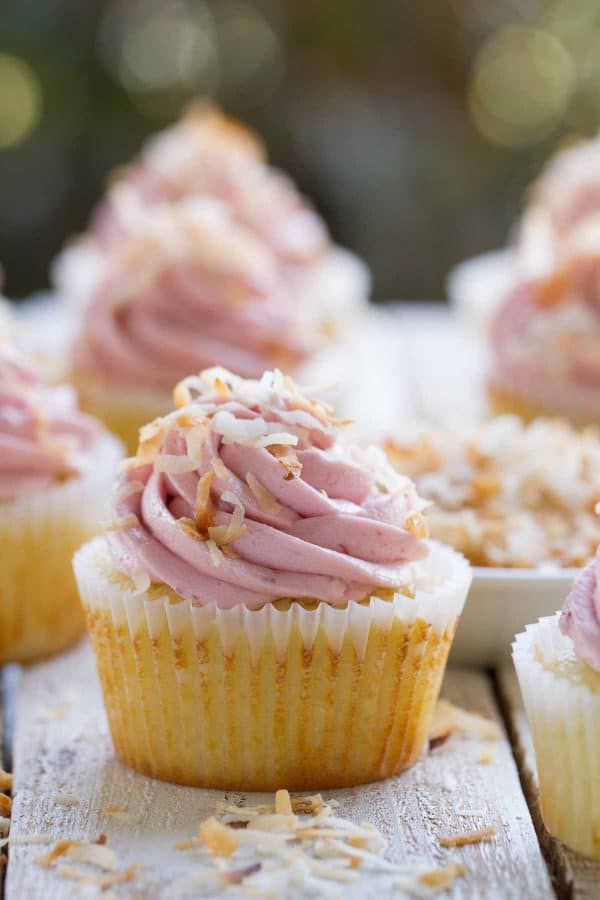 A winning flavor combination – these Raspberry Coconut Cupcakes are coconut cupcakes filled with raspberry jam and then topped with a smooth and creamy raspberry buttercream. Don’t worry if raspberries aren’t in season – you use jam, making these perfect year round!