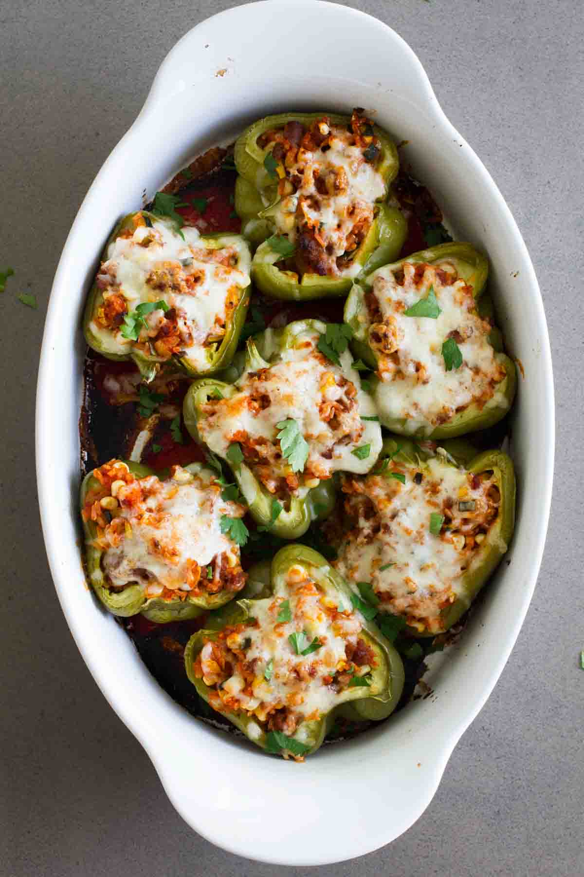 Baking dish full of Vegetable and Sausage Stuffed Peppers