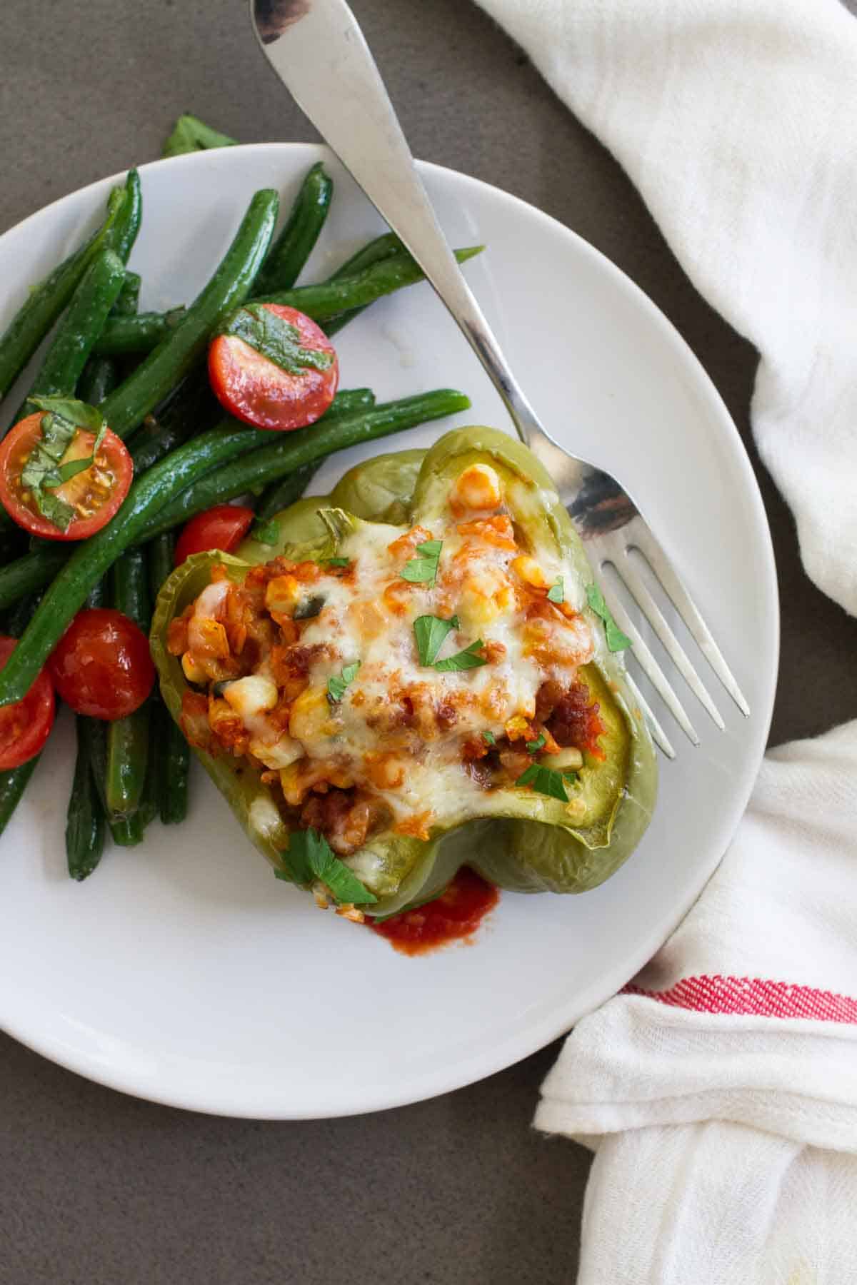 Plate with Vegetable and Sausage Stuffed Pepper with a side of green beans