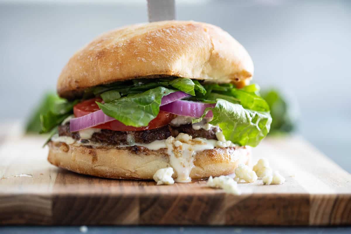 Nothing beats a juicy burger - especially when it’s topped with blue cheese! These Blue Cheese Burgers are simple yet filled with flavor. Blue Cheese Burger on a cutting board