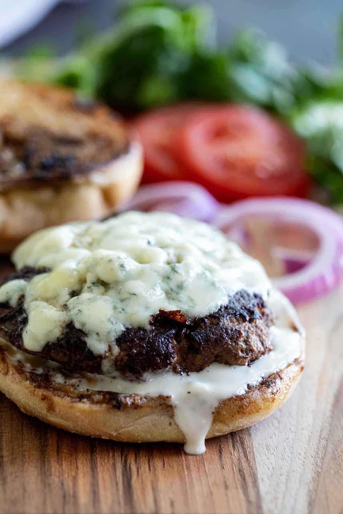 Burger topped with blue cheese and blue cheese dressing