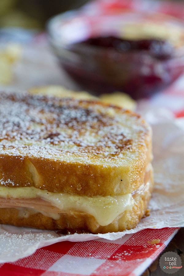 A mash up of 2 favorite sandwiches - a ham and cheese sandwich is slathered with a béchamel sauce, then battered and cooked in a skillet Monte Cristo style. Top with powdered sugar and raspberry jam if desired!