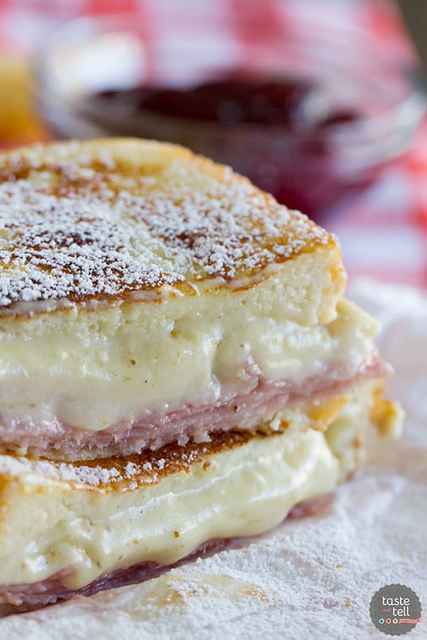 A mash up of 2 favorite sandwiches - a ham and cheese sandwich is slathered with a béchamel sauce, then battered and cooked in a skillet Monte Cristo style. Top with powdered sugar and raspberry jam if desired!