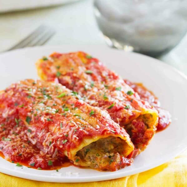 Now this is Sunday dinner! This Stuffed Manicotti with Beef has a slow cooked beef mixture that is combined with ham and cheese and stuffed in manicotti pasta. And if you make the sauce ahead of time, you can make this an easy weeknight dinner!