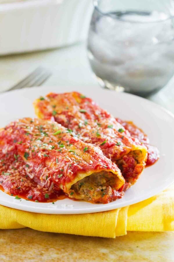 Now this is Sunday dinner! This Stuffed Manicotti with Beef has a slow cooked beef mixture that is combined with ham and cheese and stuffed in manicotti pasta. And if you make the sauce ahead of time, you can make this an easy weeknight dinner!