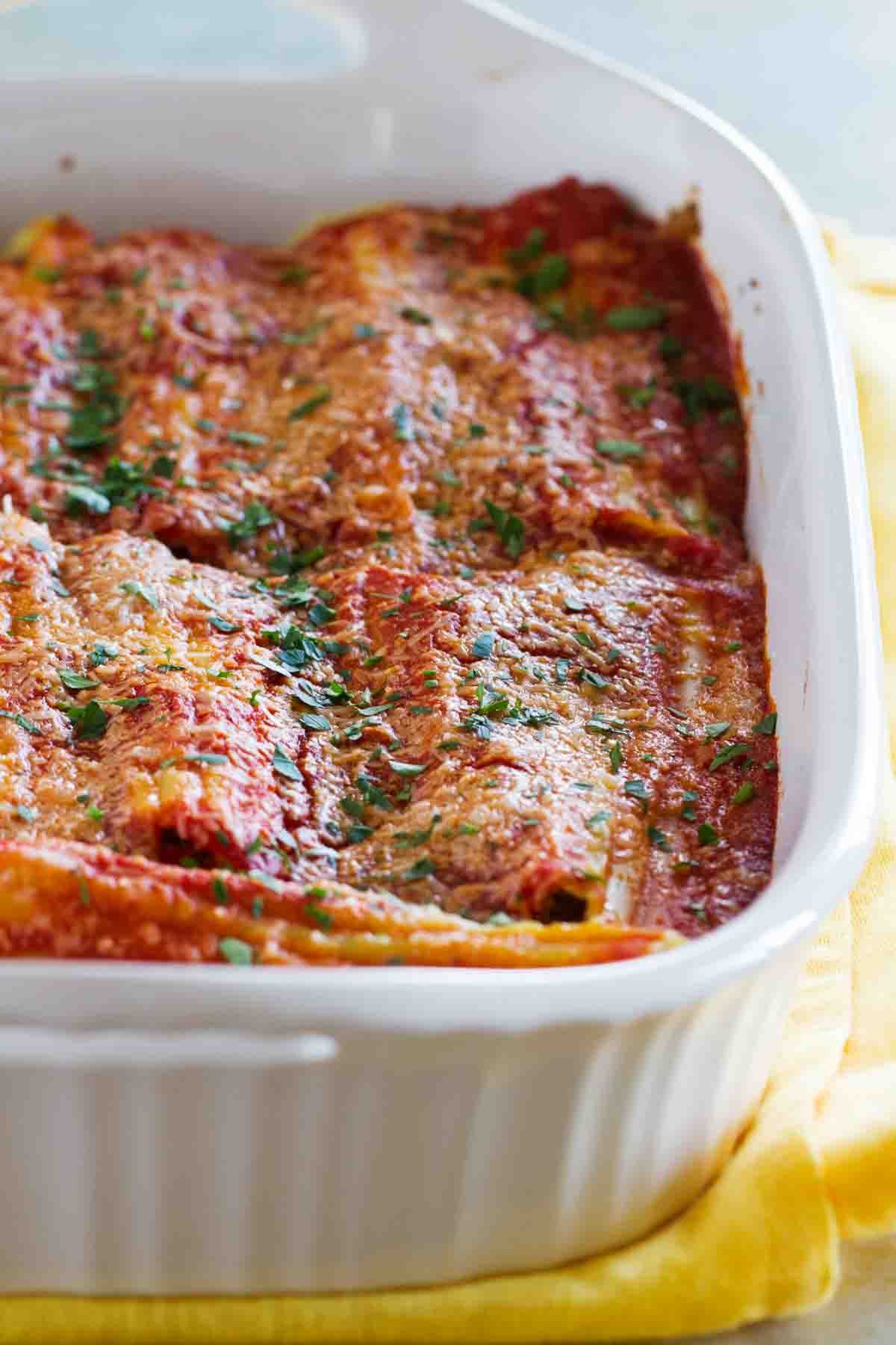 Stuffed Manicotti with Beef in a white casserole dish.