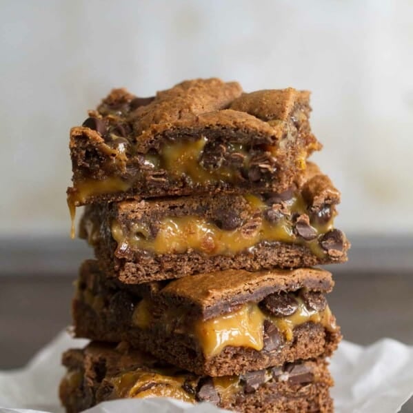 Caramel Brownies stacked on top of each other.