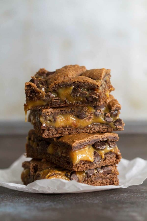Caramel Brownies stacked on top of each other.