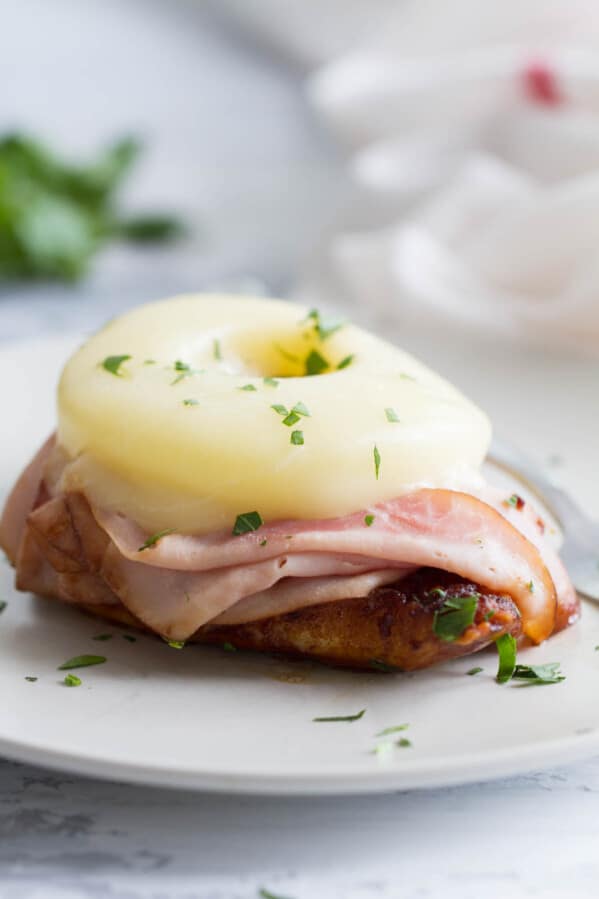 Dinner in a hurry - this Hawaiian Chicken with Ham and Pineapple cooks up in less than 30 minutes. Soy sauce seasoned chicken is topped with ham, pineapple, and melty cheese for a dinner you’ll want to make over and over again.