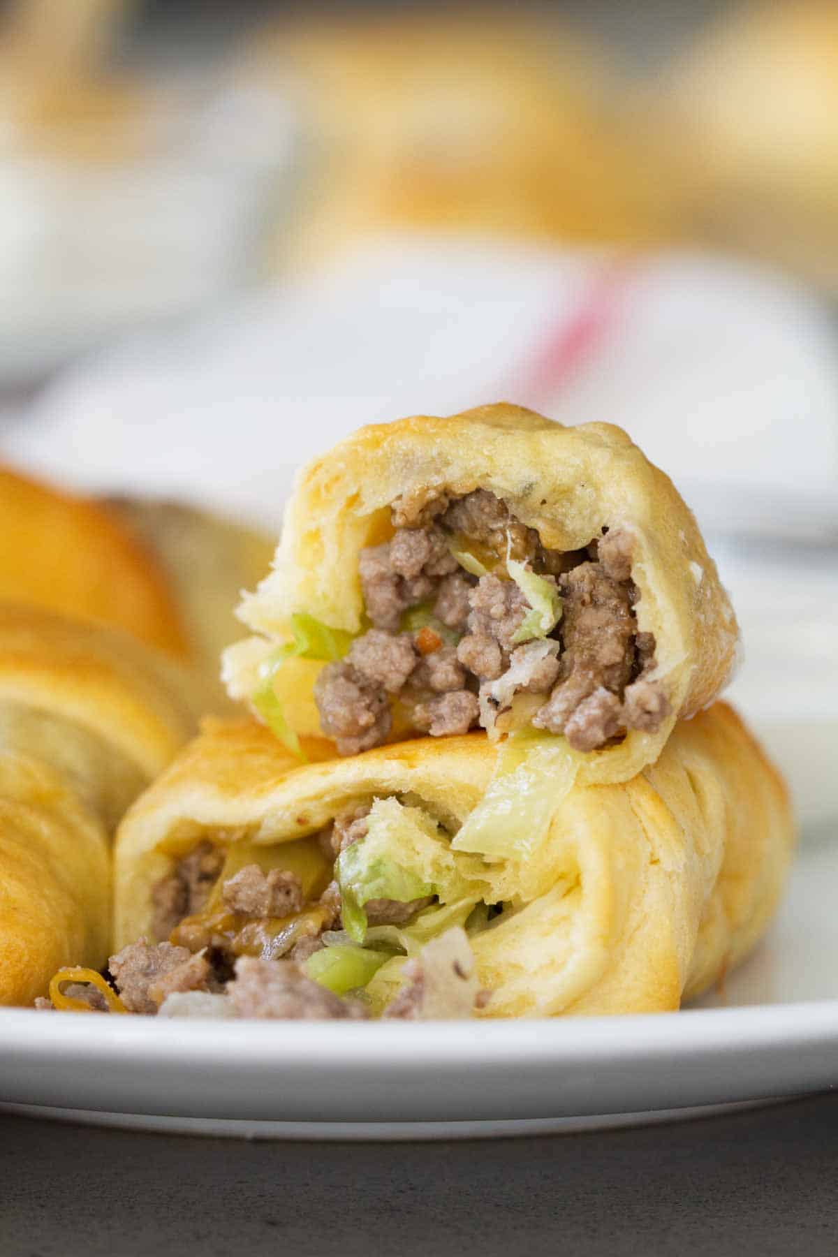 Super simple, yet super tasty, these Cabbage and Beef Bundles take a simple cabbage and beef filling and stuff it inside crescent rolls. Don’t skip the horseradish mayo for dipping! inside view of Cabbage and Beef Bundles