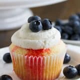 Cupcakes go patriotic with these Jello Poke Cupcakes that are streaked with red, then topped with white and blue. You can easily change the jello flavor and the topping for different holidays or flavors.