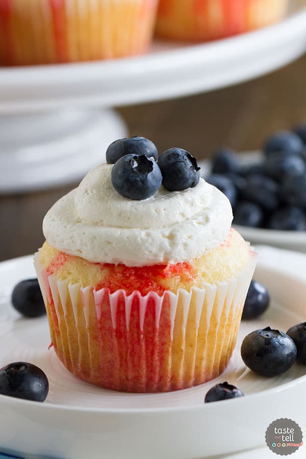 Cupcakes go patriotic with these Jello Poke Cupcakes that are streaked with red, then topped with white and blue. You can easily change the jello flavor and the topping for different holidays or flavors.