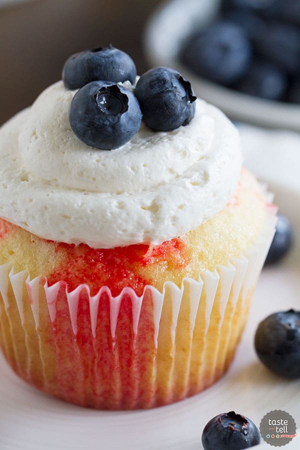 Cupcakes go patriotic with these Jello Poke Cupcakes that are streaked with red, then topped with white and blue. You can easily change the jello flavor and the topping for different holidays or flavors.