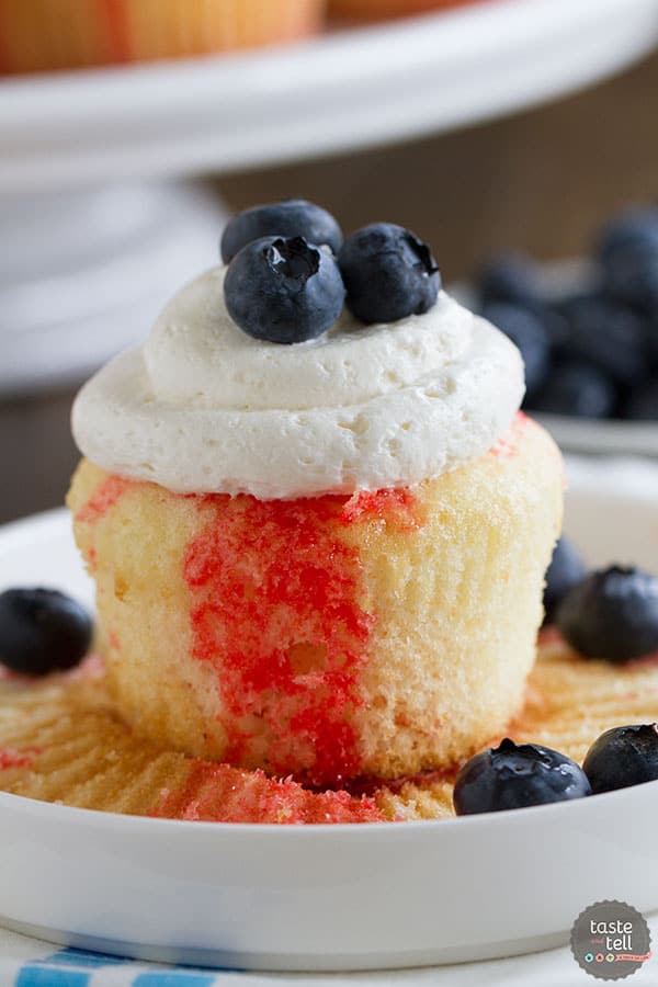 Cupcakes go patriotic with these Jello Poke Cupcakes that are streaked with red, then topped with white and blue. You can easily change the jello flavor and the topping for different holidays or flavors.