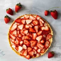 full strawberry tart topped with fresh strawberries