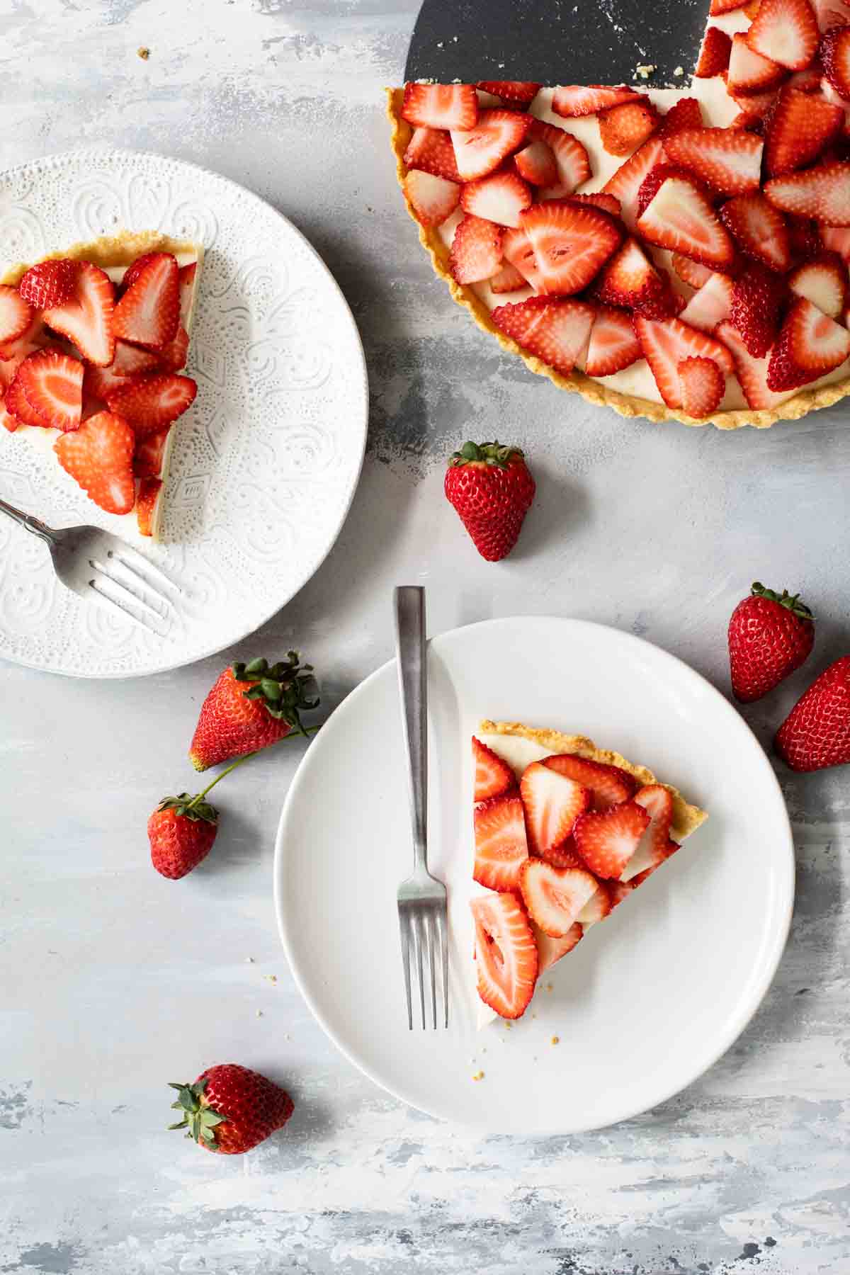 slices of strawberry tart on white plates