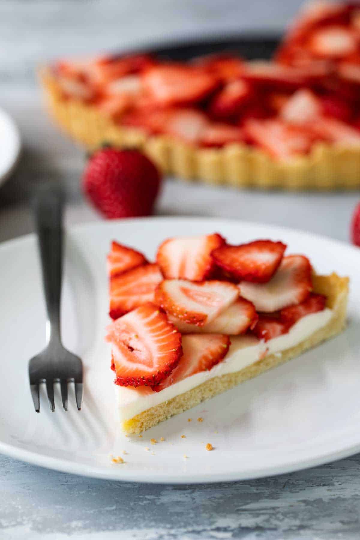Slice Strawberry and Cream Tart on a plate with a fork
